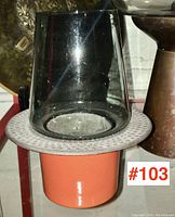 Full side view of the candle lamp showing enamel base and glass chimney