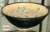 Side view of the signed Canadian studio art pottery bowl, showing dark outer glaze and textured crystalline interior.