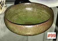 Photo of signed Canadian art pottery bowl showing the bowl shape and green-brown textured glaze