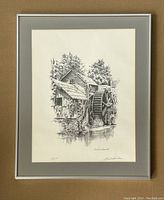 Framed signed print showing the full watermill scene and signature, edition number visible.