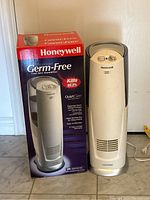 Photo of the Honeywell humidifier next to its original box showing front profile and control knobs.