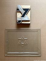 Wall art and glass platter shown together on a brown background, clear view of embossed Star of David on platter and layered Star of David wall art