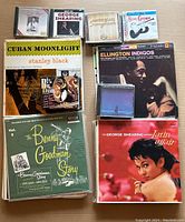 Collection of vinyl records and CDs including Latin, jazz, and big band music albums