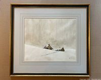 Framed signed watercolour of a winter farmhouse landscape with snow and cloudy sky, showing the overall condition and composition.