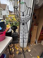 Full view of the metal ladies dress form showing its height and decorative elements