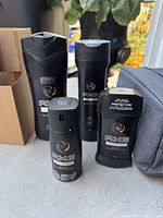 Photo showing AXE Dark Temptation four personal care products: body wash, body spray, deodorant stick, and antiperspirant stick.