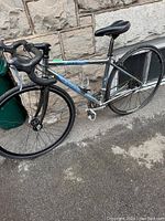 Full side view of the adult road bike showing silver and blue Dolce Sport Splendor frame, drop handlebars, and tires.
