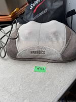 Front view of the HoMedics Shiatsu electric massage pillow with brand name embroidered on the front.