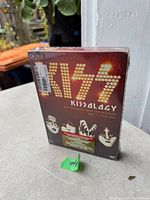 Photo of sealed 'KISS 4AL4CY The Ultimate KISS Collection Vol 3 1978-1991' DVD box set showing front cover with band member faces and KISS logo.