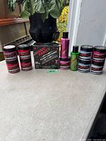 Full view of the lot items on countertop showing all jars of hair color and the hair lightening kit box.