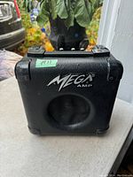 Front view of the Mega Amp showing the built-in speaker and logo