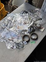 Wide view of assorted new costume jewellery items in individual plastic packaging laid out on a table