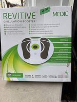 Front view of the Revitive Medic Circulation Booster box showing the product image and key features in English and French.