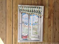 Framed watercolour painting showing an open window looking out onto a beach scene with coastal elements.