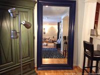 Full view of the large rectangular mirror with a heavy blue wooden frame, showing its size relative to nearby furniture.