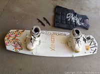 Full view of wakeboard with white boots attached, O'Neill vest and additional parts included
