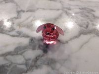 Front angled view of pink crystal bunny figurine showing facial details and clear pink ears.