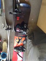 Top and side views of SIMS snowboard showing bindings and surface condition.
