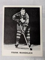 Front of hockey card showing Frank Mahovlich in Toronto Maple Leafs uniform with hockey stick.