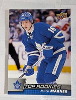 Front of Mitch Marner rookie card showing player in blue Toronto Maple Leafs uniform, Top Rookies logo, and Upper Deck logo.