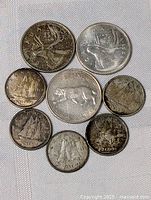 Clear top-down view of Canada silver coins showing designs and condition.