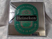 Full view of vintage Heineken Lager Beer mirror showing green and silver logo design.