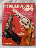 Front cover of the book featuring images of a revolver and pistol with title and author name