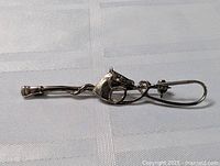 Side view of the sterling silver brooch pin showing the detailed horse head and riding crop design