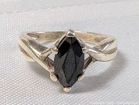 Front view of the sterling silver ring with marquise-shaped black onyx stone showing prong setting and polished band.