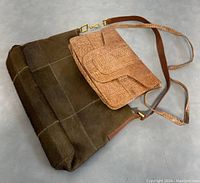 Two brown 1970s designer bags of different sizes and styles photographed together on gray surface
