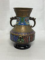 Front view of antique cloisonne enamel brass vase showing body design, multicolor enamel bands, and dual stylized handles.