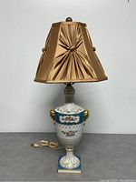 Full view of the lamp including urn base and fabric shade, showing condition and overall appearance.