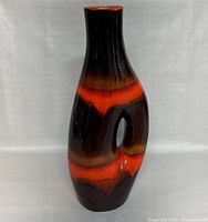 Front view of the tall 20 inch pottery vase showing the orange and brown gradient glaze and unique hole feature