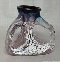 Side view of modern hand blown art glass vase showing clear and purple glass with white speckles and hollow structure
