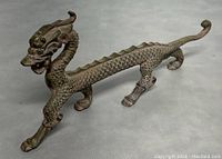 Full side view of the metal Asian griffon dragon figurine showing body length and detail.