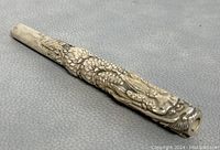 Close-up side angle showing the dragon design wrapping around the pipe.