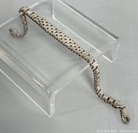 Photo showing the 8-inch 925 silver bracelet displayed on a clear stand highlighting the design and clasp.
