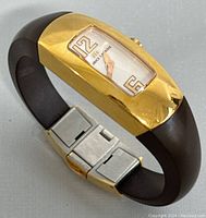 Full view of Maurice Lacroix watch showing gold plated case, black bracelet, and clasp