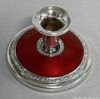 Top view showing red guilloche enamel and decorative silver band around base