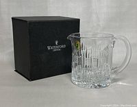 Waterford Crystal pitcher with accompanying original black box labeled 'Waterford Crystal'.
