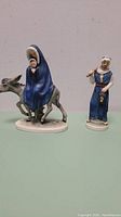 Both porcelain figurines together showing the full lot and condition.