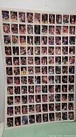 Uncut sheet of basketball cards showing the complete grid of cards containing 90 images of basketball players.