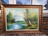 Front view of the original oil on canvas landscape painting showing the river, trees, and mountains with vibrant colors.