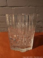 Front view of clear mold-blown crystal vase showing vertical ridges and textured bubble pattern.