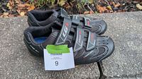 Pair of Louis Garneau black road bike shoes size 41 viewed from side showing strapped closures and logos.
