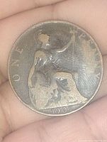 Reverse side of the 1907 English Large Penny showing seated Britannia with shield and trident, denomination and year.