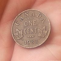 Reverse side of 1933 Canadian one cent coin showing denomination, two maple leaves, and date 1933.