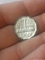 Reverse side of the 1951 Sudbury Nickel showing Canada, denomination, and mining design.