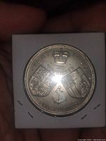 Close-up of reverse side with crown, shields, date range 1947-1997, 20 November date and denomination five pounds.