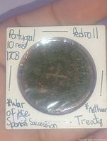 Obverse side of the coin with handwritten labeling on holder referencing Portugal, Pedro II, 10 Reis, 1703, War of the Spanish Succession, and Methuen Treaty.